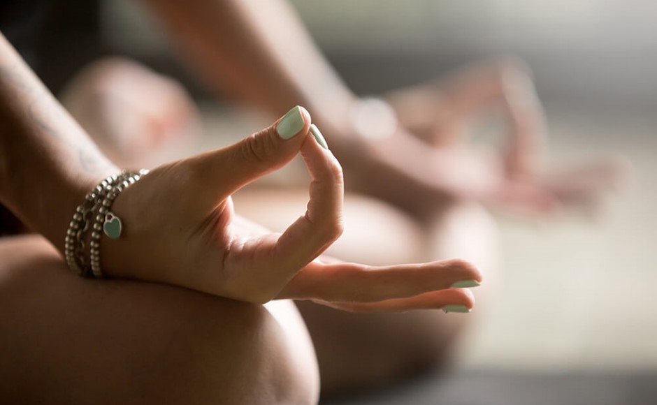 Gyan mudra close up, woman joining together the tip of index finger with thumb