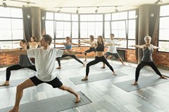 Millennials practicing yoga in a modern studio stock photo