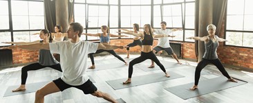 Millennials practicing yoga in a modern studio stock photo